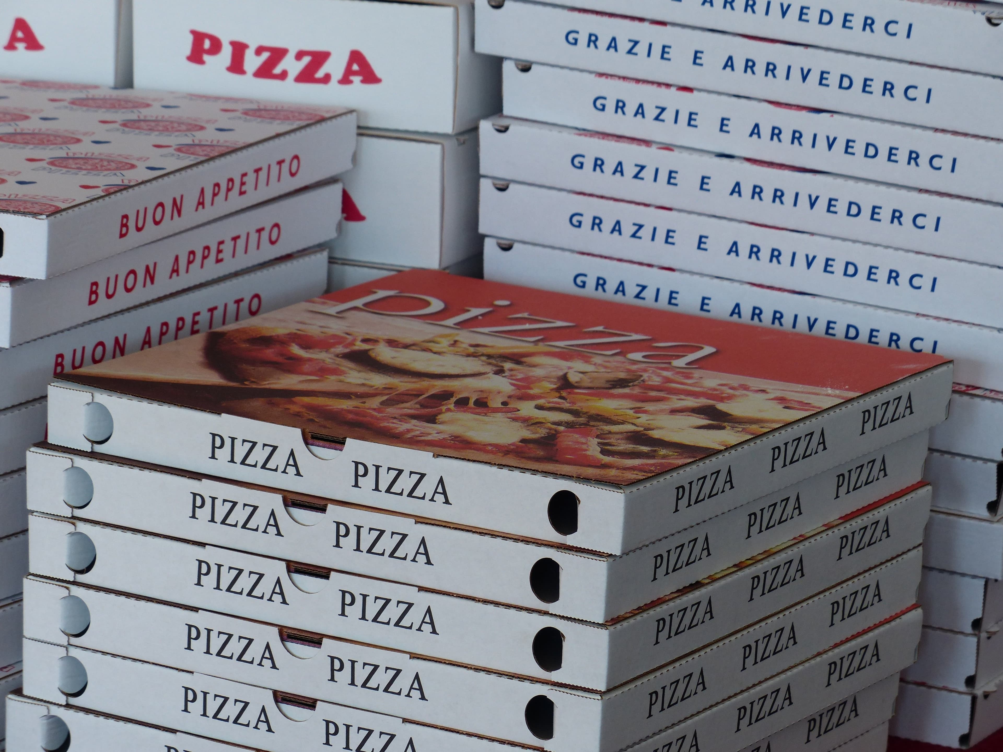 Stacked pizza boxes representing a food delivery order